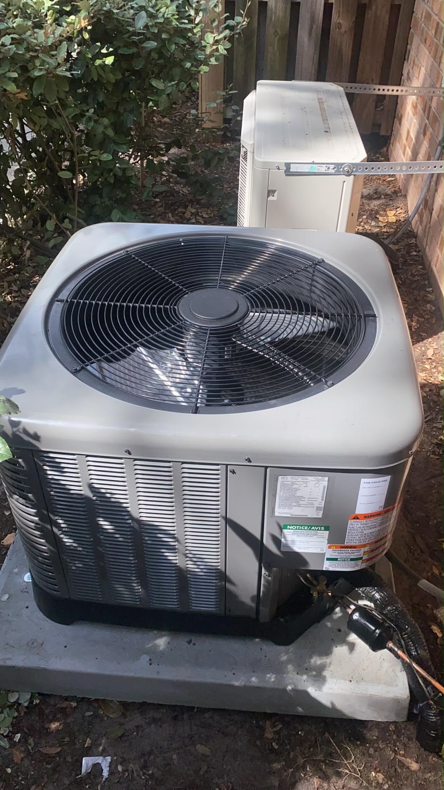 Technician servicing commercial HVAC equipment