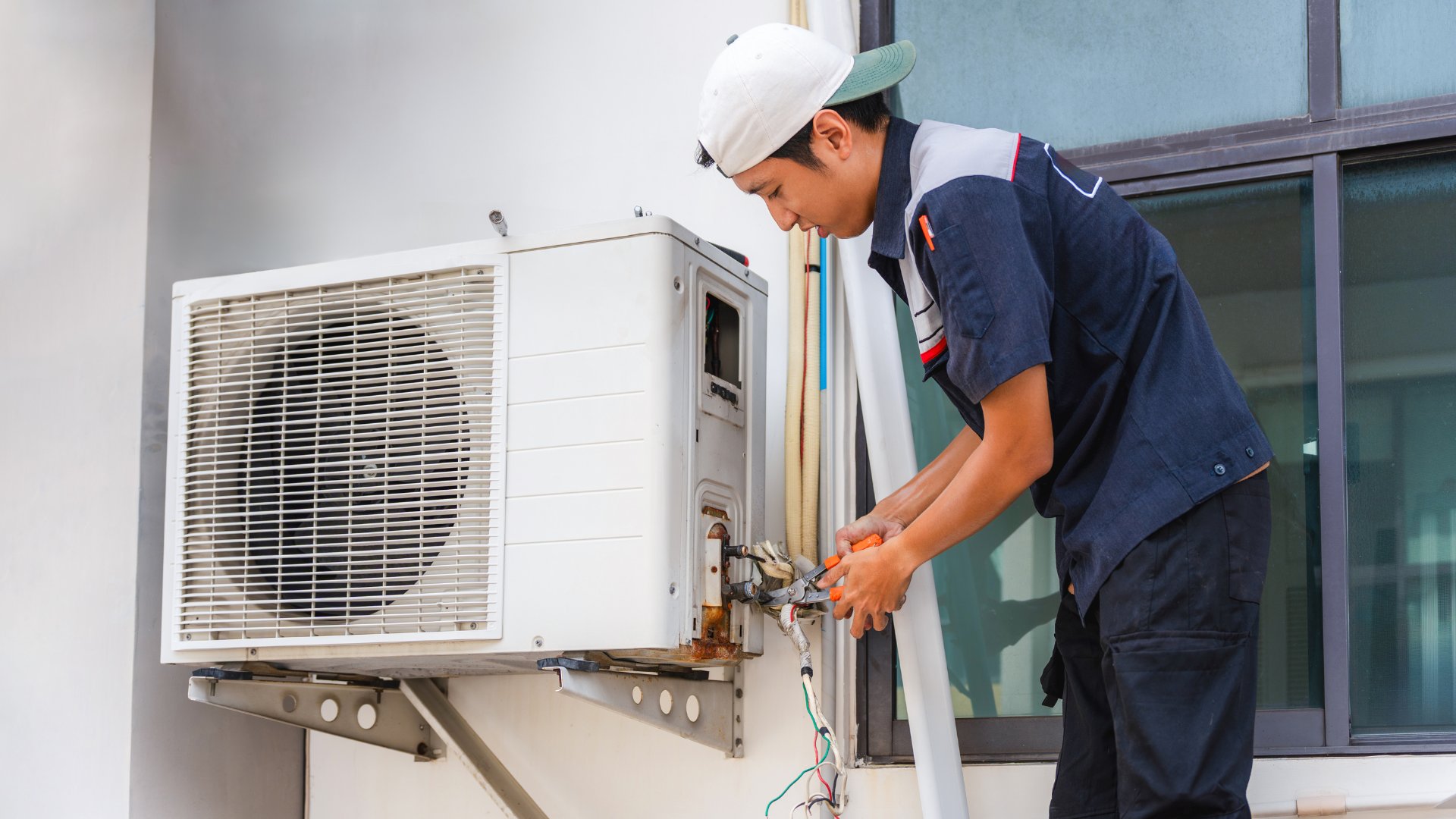 Technician repairing HVAC unit